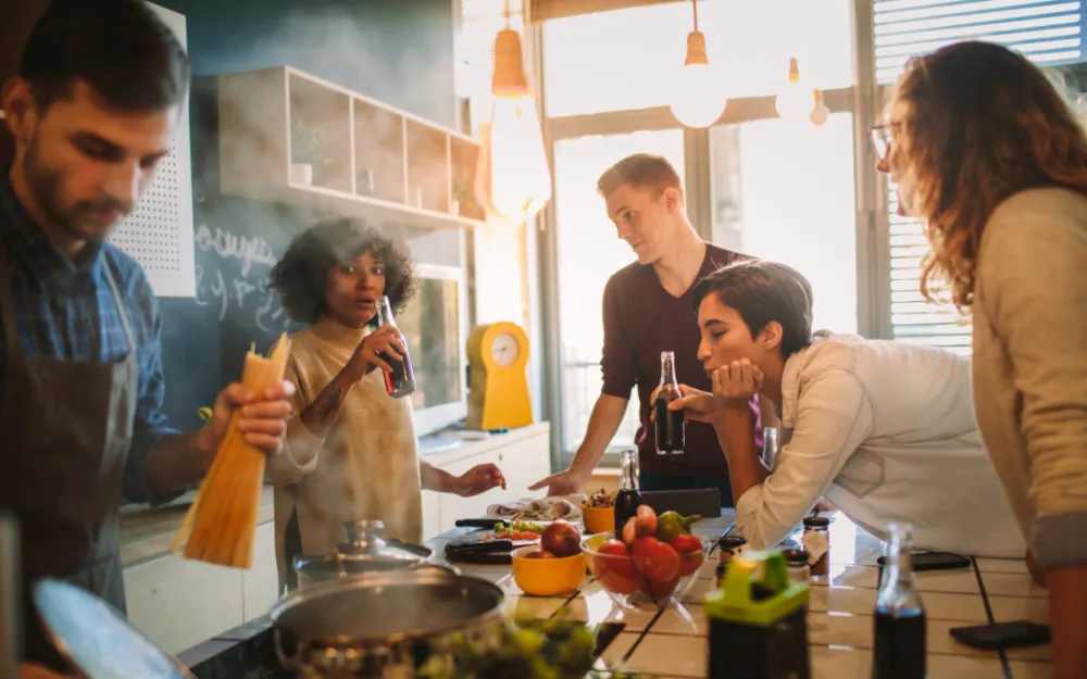 Friends preparing a meal together in a kitchen