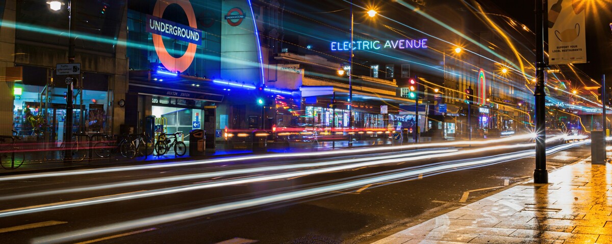 Electric Avenue and Brixton station at night, traffic passing in long streaks of light