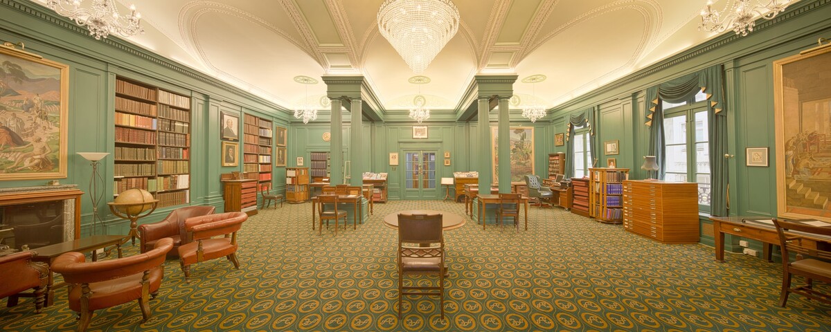 A long library hall lined with bookshelves