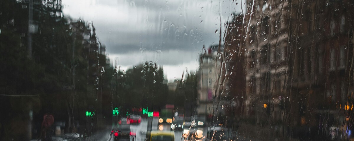 A London street seen through the rain on a bus window