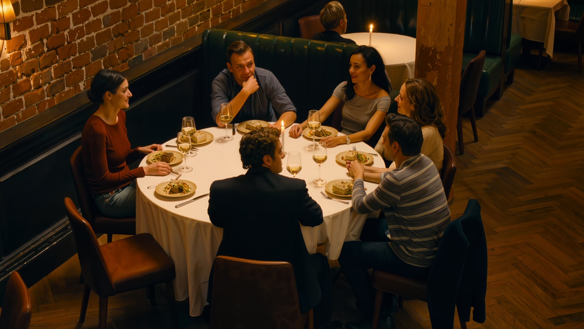 A table of six at a candlelit London restaurant in the evening